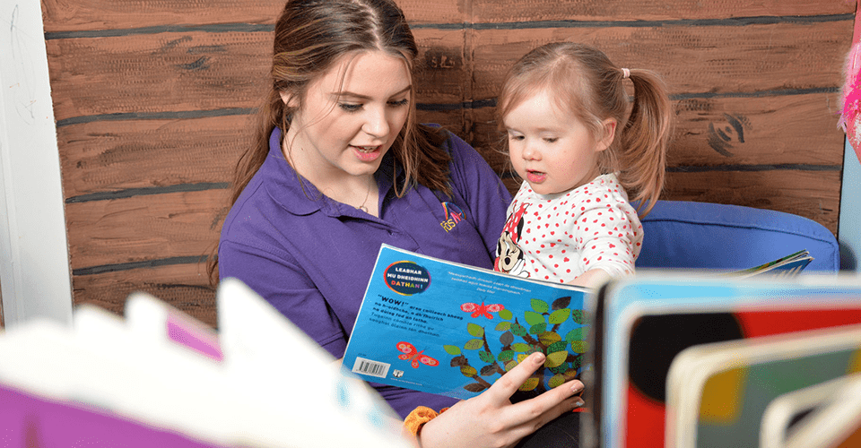children-young-people-banner-960x500 Picture of a student reading to a child