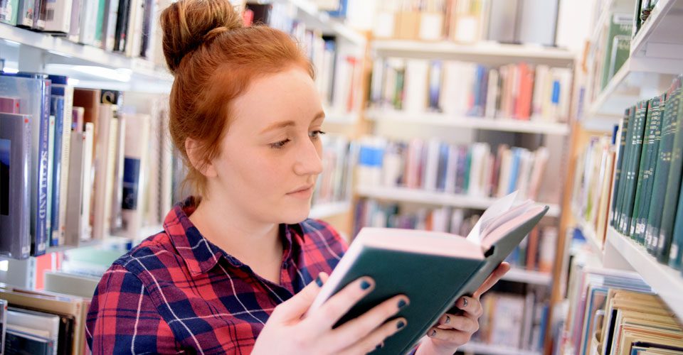 Picture of a student reading a book