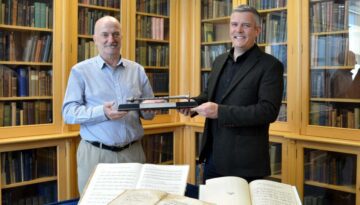 Rob Wallace Pìobaireachd Society hands Silver Chanter over to Dr Decker Forrest in Sabhal Mòr Ostaig library